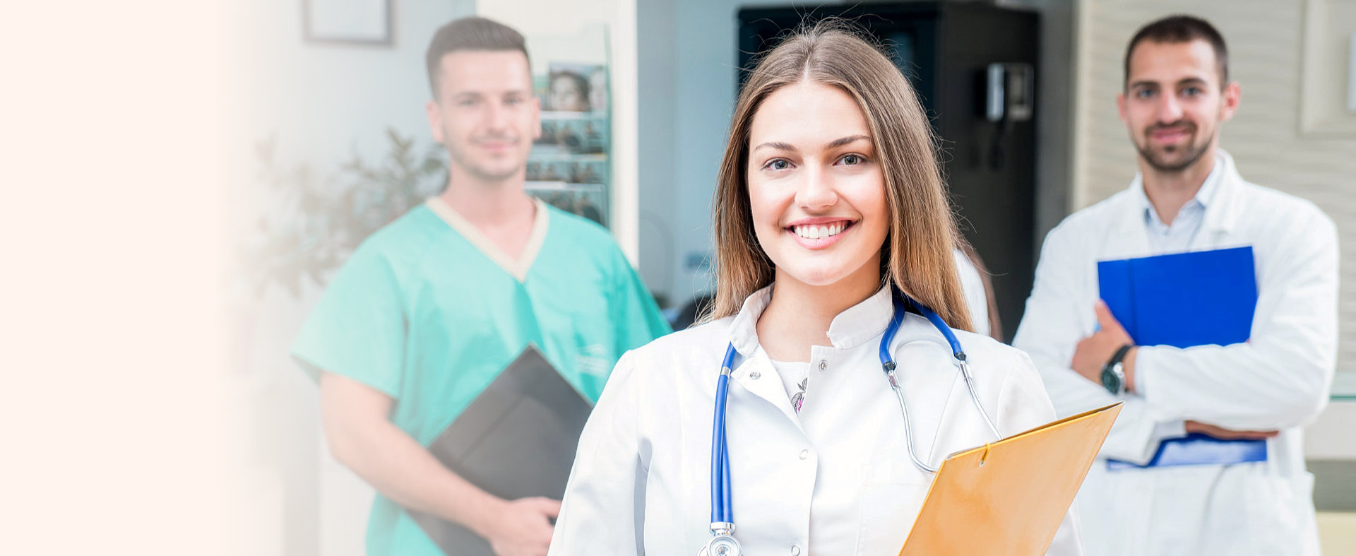 medical personnel holding portfolios smiling at the camera